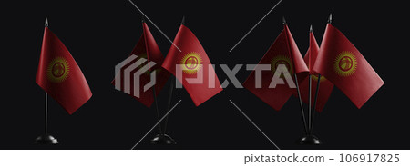 Small national flags of the Kirghizia on a black background Small national flags of the Kirghizia on a black background 106917825