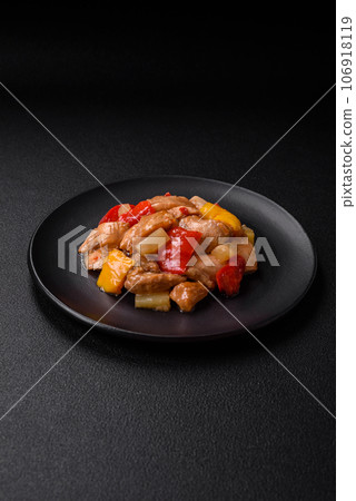 A delicious dish consisting of slices of chicken, sweet peppers and onions 106918119