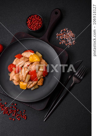 A delicious dish consisting of slices of chicken, sweet peppers and onions 106918127