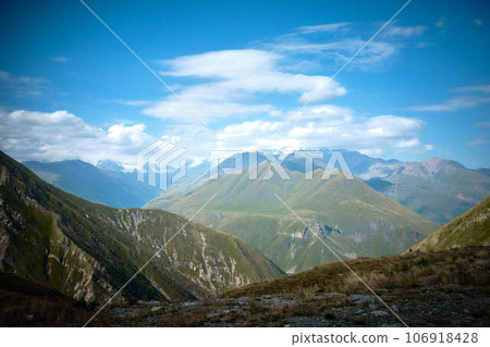 Mountain ranges on a sunny day at Georgia. Sky with clouds adn hills 106918428