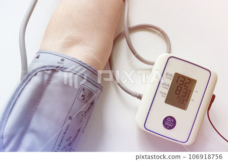 Man check blood pressure monitor and heart rate monitor with digital pressure gauge. Health care and Medical concept 106918756