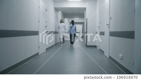 Mature medic opens door for his colleague and old woman Mature medic opens door for his colleague and old woman 106918970