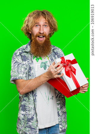 Man opening birthday gift box with red ribbon, receiving great present surprise, celebrating Man opening birthday gift box with red ribbon, receiving great present surprise, celebrating 106919013
