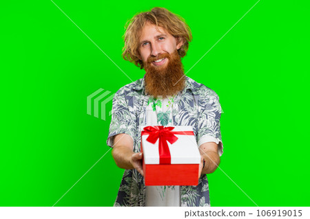 Smiling man presenting birthday gift present box stretches out hands, promotion discount sale Smiling man presenting birthday gift present box stretches out hands, promotion discount sale 106919015