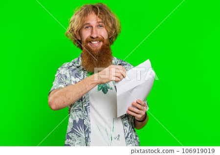 Happy young man open envelope take out letter reads, bank loan approve, great news, award, win Happy young man open envelope take out letter reads, bank loan approve, great news, award, win 106919019