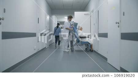 Mature medic opens door for his colleague and old woman Mature medic opens door for his colleague and old woman 106919020