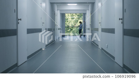 Medical staff and patients in modern hospital or medical center corridor Medical staff and patients in modern hospital or medical center corridor 106919096