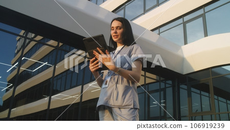 Female doctor consults patient during online appointment using digital tablet Female doctor consults patient during online appointment using digital tablet 106919239