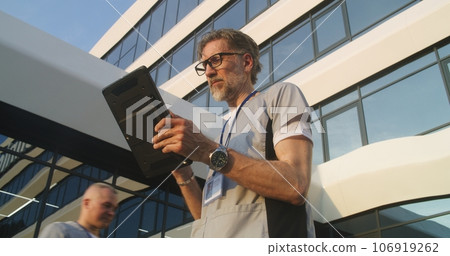 Doctor speaks with patient during online appointment using digital tablet Doctor speaks with patient during online appointment using digital tablet 106919262