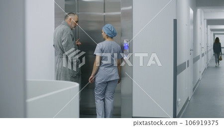 Nurse and patient walk corridor and come to lift Nurse and patient walk corridor and come to lift 106919375