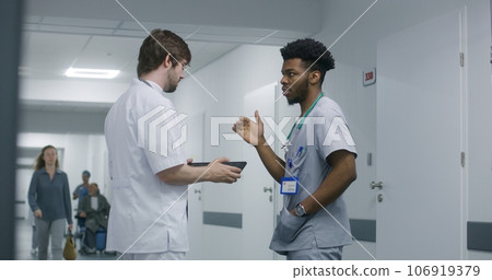 Professional doctor shows MRI or CT scan results to colleague 106919379
