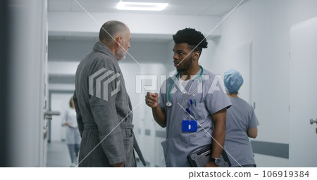 African American doctor asks elderly patient about his health African American doctor asks elderly patient about his health 106919384