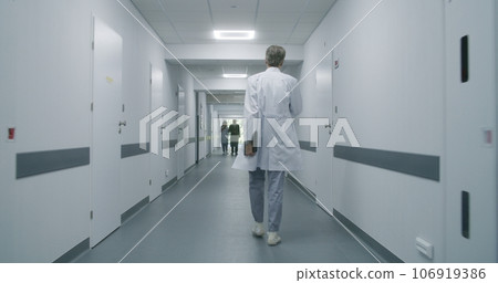 Professional medic stops to talk to colleague and old patient 106919386