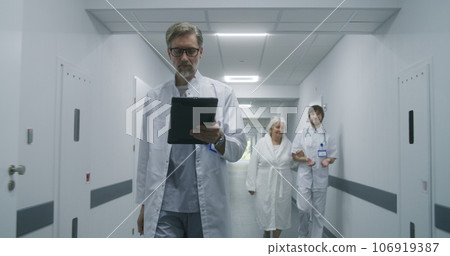 Female medic goes to medical room with old patient Female medic goes to medical room with old patient 106919387