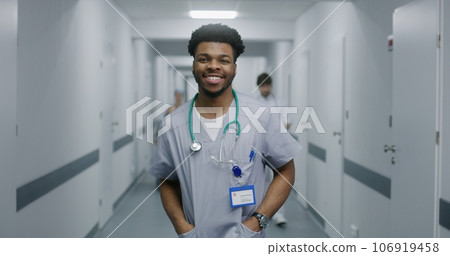 Young doctor stands in middle of hospital corridor 106919458
