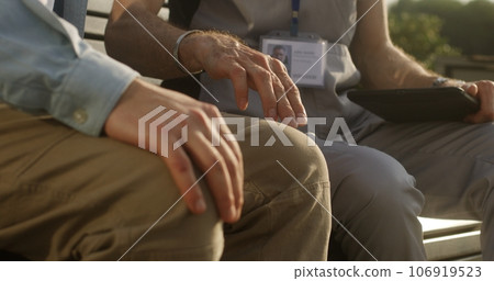 Man touches leg and complains of pain to doctor Man touches leg and complains of pain to doctor 106919523