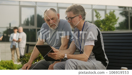 Mature doctor makes diagnosis to elderly patient Mature doctor makes diagnosis to elderly patient 106919553