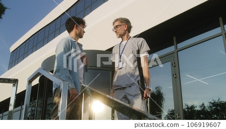 Doctor with tablet consults patient at entrance 106919607