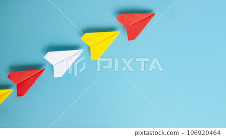 Top view of red paper airplane origami leading other paper airplanes. With copy space for text Top view of red paper airplane origami leading other paper airplanes. With copy space for text 106920464