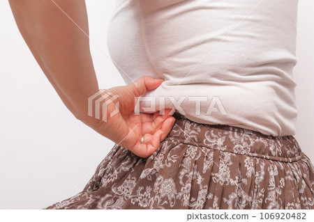 [Housewife picking meat from her belly] 106920482