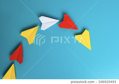 Top view of yellow paper plane origami leading other paper planes. With copy space. Top view of yellow paper plane origami leading other paper planes. With copy space. 106920493