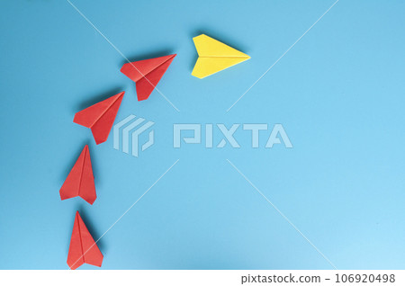 Top view of yellow paper plane origami leading red paper planes. With copy space for text Top view of yellow paper plane origami leading red paper planes. With copy space for text 106920498