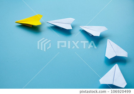 Side view of yellow paper airplane origami leading white paper airplanes. Leadership concept Side view of yellow paper airplane origami leading white paper airplanes. Leadership concept 106920499