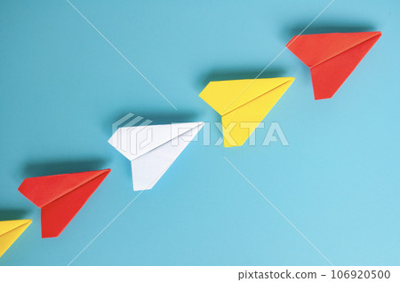 Top view of red paper airplane origami leading other paper airplanes. With copy space for text. 106920500