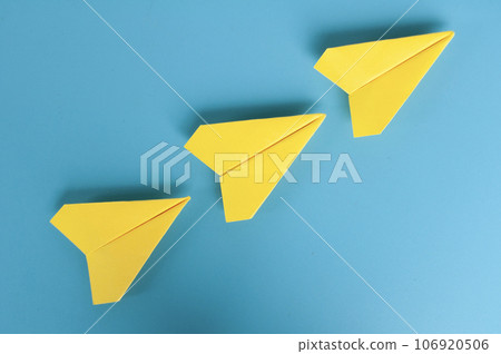 Top view of yellow paper airplanes with space for text Top view of yellow paper airplanes with space for text 106920506