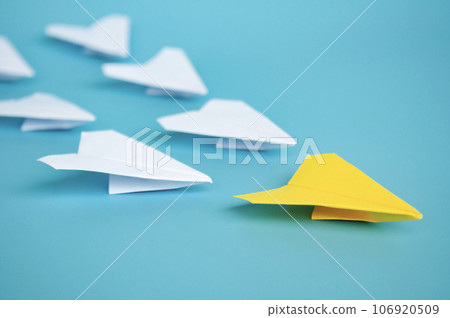 Yellow paper plane origami leading other white paper planes on blue background. Leadership concept Yellow paper plane origami leading other white paper planes on blue background. Leadership concept 106920509