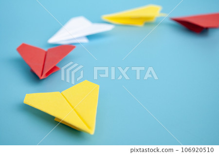Yellow paper plane origami leading other paper planes on blue background. Leadership and copy space. Yellow paper plane origami leading other paper planes on blue background. Leadership and copy space. 106920510