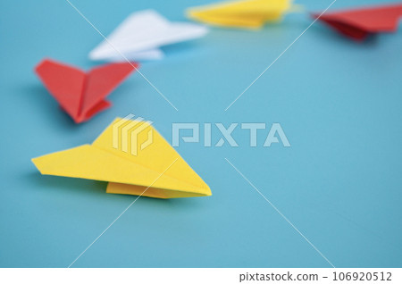 Yellow paper plane origami leading other paper planes on blue background. Leadership concept. Yellow paper plane origami leading other paper planes on blue background. Leadership concept. 106920512