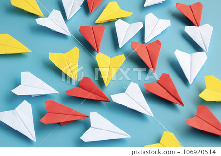 Yellow paper plane origami leading other white paper planes on blue background. Leadership concept. Origami concept. Yellow paper plane origami leading other white paper planes on blue background. Leadership concept. Origami concept. 106920514
