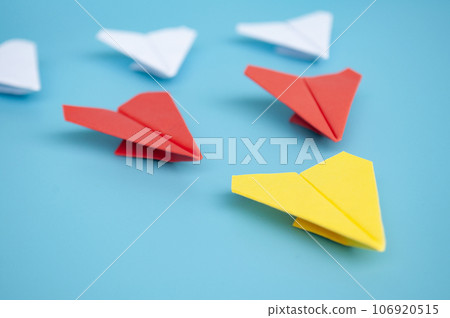Yellow paper plane origami leading other paper planes on blue background. Leadership and copy space concept. Yellow paper plane origami leading other paper planes on blue background. Leadership and copy space concept. 106920515