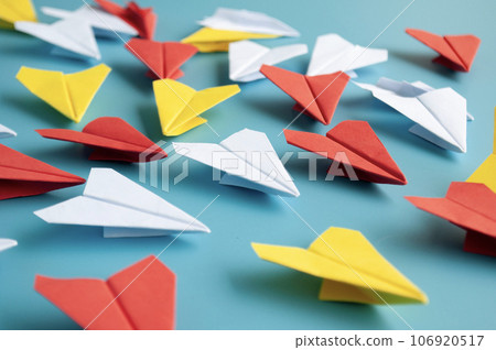 Yellow paper plane origami leading other white paper planes on blue background. Leadership concept. Origami concept. Yellow paper plane origami leading other white paper planes on blue background. Leadership concept. Origami concept. 106920517