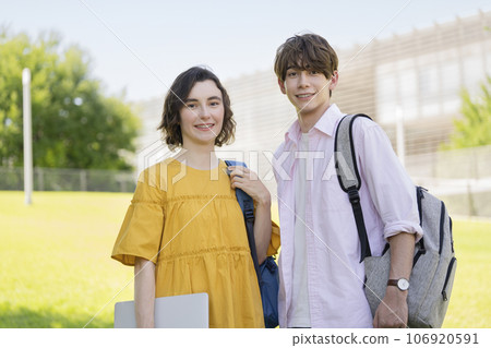Male and female university students smiling at the camera Male and female university students smiling at the camera 106920591