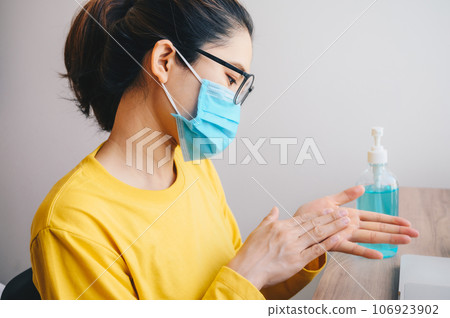 Asian woman cleaning her hands by using hand sanitizer gel. Washing your hands is one of the easiest ways to protect yourself and others from illness. Asian woman cleaning her hands by using hand sanitizer gel. Washing your hands is one of the easiest ways to protect yourself and others from illness. 106923902
