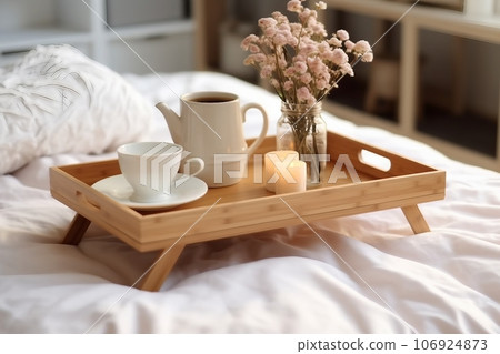 Wooden tray with coffee and interior decor on the bed with white linen Wooden tray with coffee and interior decor on the bed with white linen 106924873
