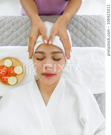 Soak in the tranquil ambiance as a woman luxuriates in therapeutic bliss. Lying on a massage table, her body is expertly attended to by the skilled palms of a masseuse. Soak in the tranquil ambiance as a woman luxuriates in therapeutic bliss. Lying on a massage table, her body is expertly attended to by the skilled palms of a masseuse. 106925811