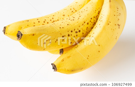 Banana with sugar spots starting to appear, black spots, brown spots 106927499