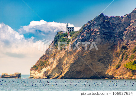 Cape Miseno with its lighthouse in Pozzuoli gulf Cape Miseno with its lighthouse in Pozzuoli gulf 106927634