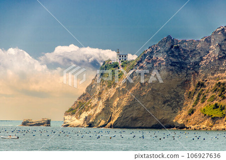 Cape Miseno with its lighthouse in Pozzuoli gulf Cape Miseno with its lighthouse in Pozzuoli gulf 106927636