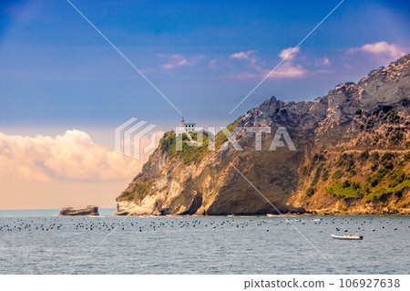 Cape Miseno with its lighthouse in Pozzuoli gulf Cape Miseno with its lighthouse in Pozzuoli gulf 106927638