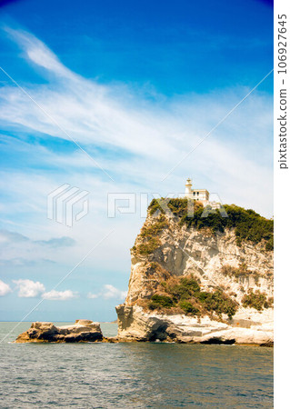 Cape Miseno with its lighthouse in Pozzuoli gulf Cape Miseno with its lighthouse in Pozzuoli gulf 106927645