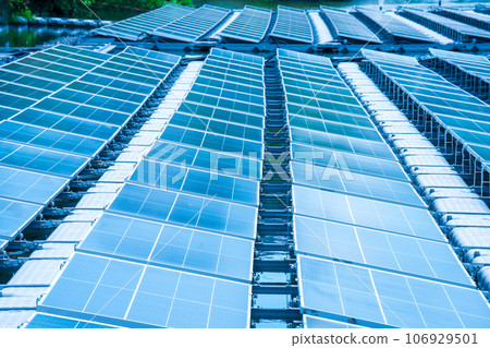 Side view of solar panels floating on water in a lake, for generating electricity from sunlight, selective focus, soft focus. Side view of solar panels floating on water in a lake, for generating electricity from sunlight, selective focus, soft focus. 106929501