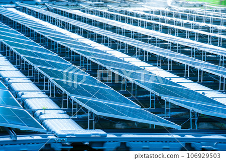 Side view of solar panels floating on water in a lake, for generating electricity from sunlight, selective focus, soft focus. Side view of solar panels floating on water in a lake, for generating electricity from sunlight, selective focus, soft focus. 106929503