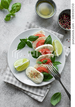 Caprese salad with tomatoes, mozzarella and basil. Caprese salad with tomatoes, mozzarella and basil. 106930350