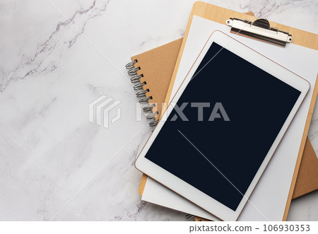 Tablet pc and notebooks on the office desk Tablet pc and notebooks on the office desk 106930353