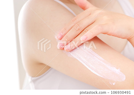 Woman applying cream to her arm for beauty Woman applying cream to her arm for beauty 106930491