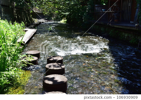Mishima Genbei River walking path with stones and wooden deck Mishima Genbei River walking path with stones and wooden deck 106930909